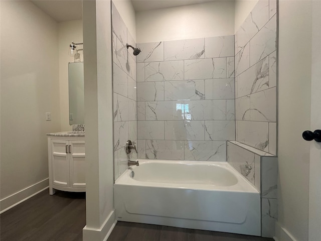 907 Davis St S, Sulphur Springs, TX 75482 - full bathroom with wood finished floors, vanity, baseboards, and tub / shower combination