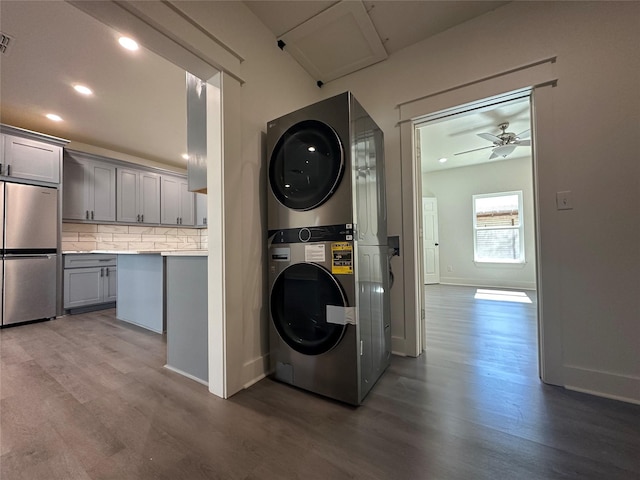 907 Davis St S, Sulphur Springs, TX 75482 - laundry area with stacked washer / dryer, wood finished floors, recessed lighting, a ceiling fan, and baseboards