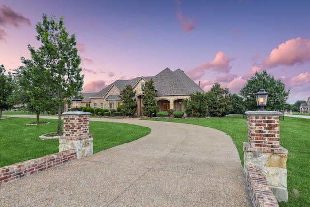 2711 Bauer Ct, Lucas, TX 75002 - french country style house featuring a front yard, curved driveway, and stone siding