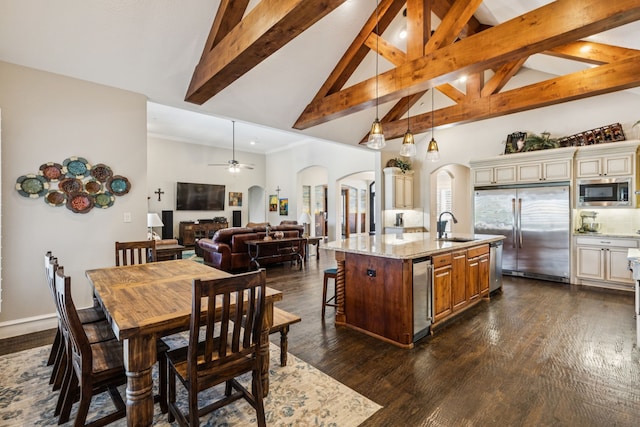 2711 Bauer Ct, Lucas, TX 75002 - kitchen with arched walkways, cream cabinets, built in appliances, high vaulted ceiling, and light stone counters