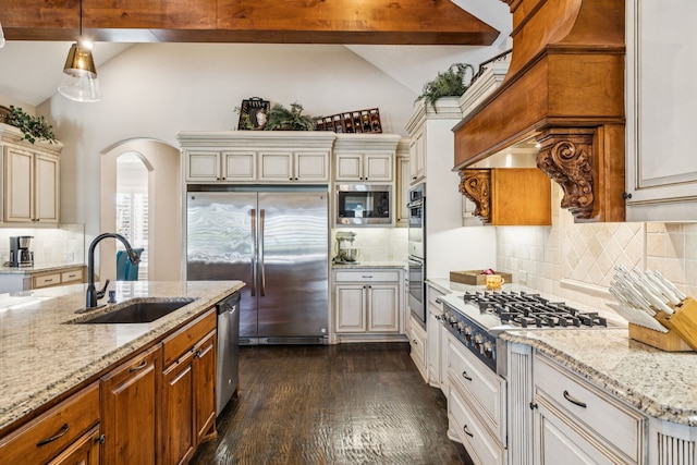 2711 Bauer Ct, Lucas, TX 75002 - kitchen with a sink, built in appliances, arched walkways, light stone countertops, and tasteful backsplash
