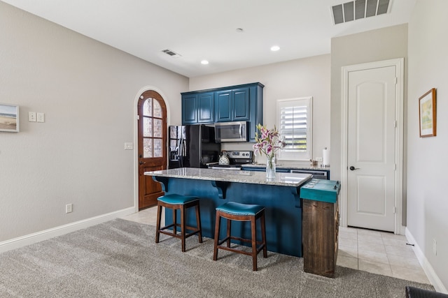 2711 Bauer Ct, Lucas, TX 75002 - kitchen featuring stainless steel appliances, blue cabinetry, a center island, a kitchen bar, and plenty of natural light