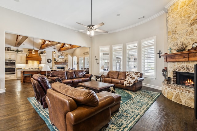 2711 Bauer Ct, Lucas, TX 75002 - living room featuring a stone fireplace, plenty of natural light, ceiling fan, dark wood-style flooring, and crown molding