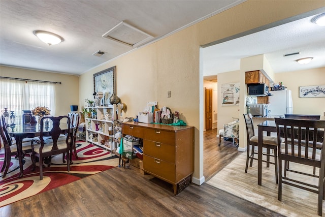 416 S 1st St, Wylie, TX 75098 - dining area featuring wood finished floors, attic access, and crown molding