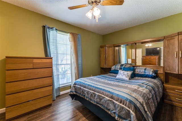 416 S 1st St, Wylie, TX 75098 - bedroom featuring multiple windows, dark wood-style flooring, a textured ceiling, and ceiling fan