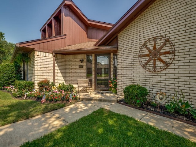 1507 Juniper Ln, Lewisville, TX 75077 - property entrance with brick siding and a lawn