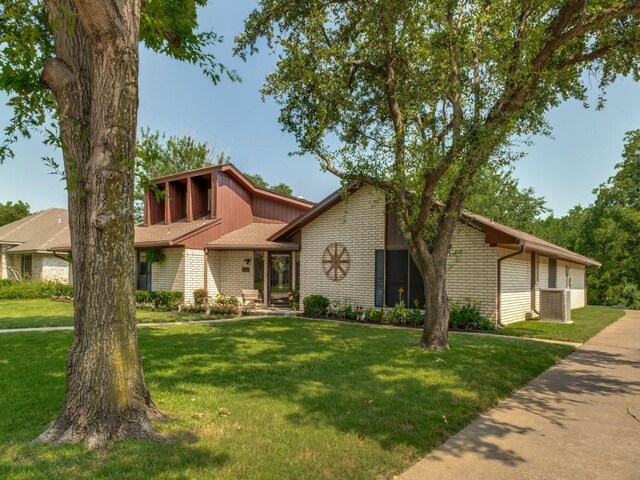 1507 Juniper Ln, Lewisville, TX 75077 - mid-century inspired home featuring brick siding and a front lawn