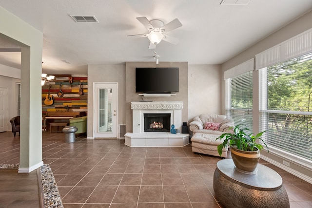 5033 Glenscape Trl, Fort Worth, TX 76137 - living area with ceiling fan, a lit fireplace, and dark tile patterned floors