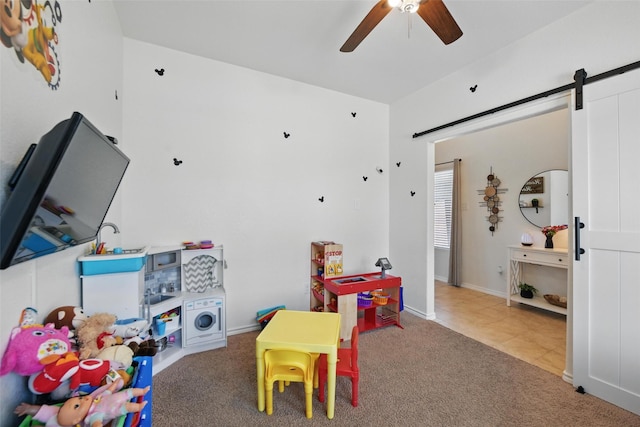 8048 Crimea Ln, Fort Worth, TX 76123 - playroom with ceiling fan, a barn door, carpet floors, tile patterned floors, and baseboards