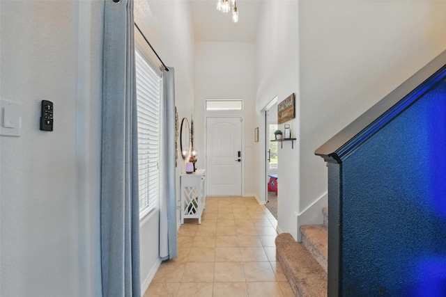 8048 Crimea Ln, Fort Worth, TX 76123 - hall with light tile patterned floors, a high ceiling, and stairway