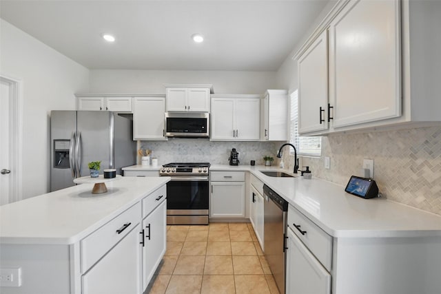 8048 Crimea Ln, Fort Worth, TX 76123 - kitchen with appliances with stainless steel finishes, a sink, white cabinetry, decorative backsplash, and recessed lighting