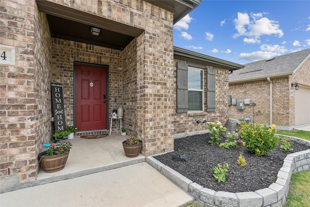 2404 Briarhurst Ct, Denton, TX 76207 - view of exterior entry with brick siding and a garage