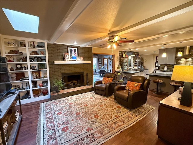 3833 Wilkie Way, Fort Worth, TX 76133 - living area with dark wood-type flooring, beamed ceiling, a fireplace, and ceiling fan
