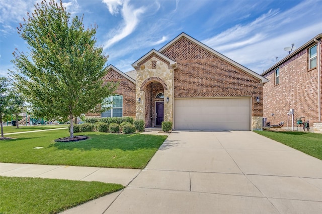 15616 Rockingham St, Frisco, TX 75036 - view of front facade featuring brick siding, concrete driveway, a garage, a front lawn, and stone siding