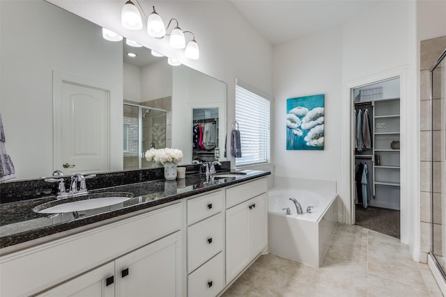 15616 Rockingham St, Frisco, TX 75036 - full bathroom with a spacious closet, a stall shower, double vanity, a garden tub, and tile patterned floors