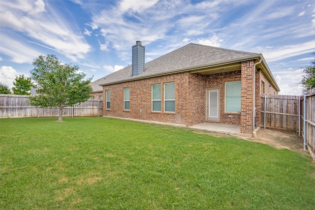 15616 Rockingham St, Frisco, TX 75036 - rear view of property featuring brick siding, a chimney, a shingled roof, and a patio area