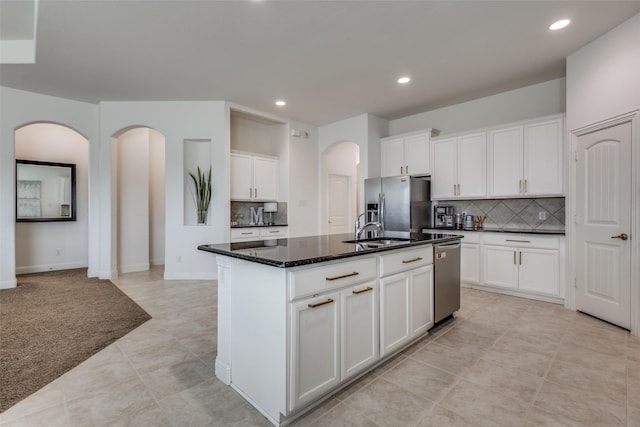 15616 Rockingham St, Frisco, TX 75036 - kitchen with stainless steel appliances, arched walkways, recessed lighting, a sink, and tasteful backsplash