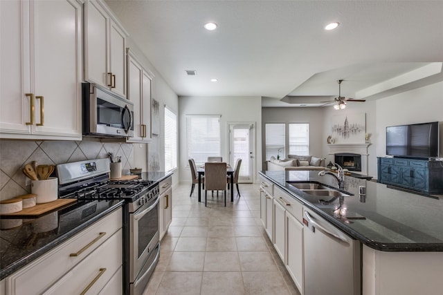 15616 Rockingham St, Frisco, TX 75036 - kitchen featuring stainless steel appliances, a sink, open floor plan, tasteful backsplash, and healthy amount of natural light