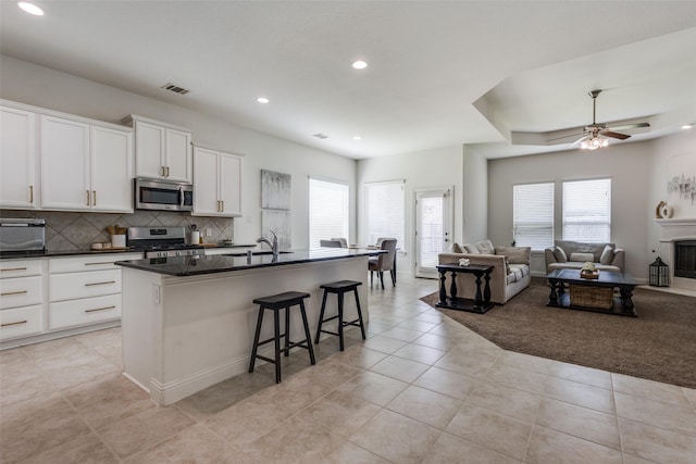 15616 Rockingham St, Frisco, TX 75036 - kitchen featuring stainless steel appliances, healthy amount of natural light, dark countertops, open floor plan, and recessed lighting
