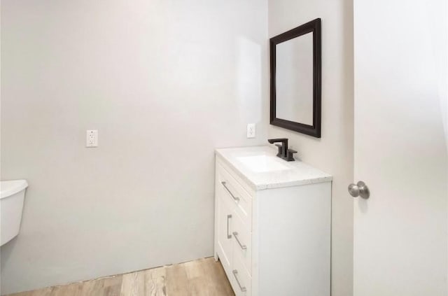 503 SW 15th Ave, Mineral Wells, TX 76067 - bathroom with vanity, toilet, and wood finished floors