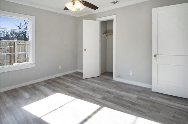 503 SW 15th Ave, Mineral Wells, TX 76067 - unfurnished bedroom with wood finished floors, baseboards, a closet, and a ceiling fan