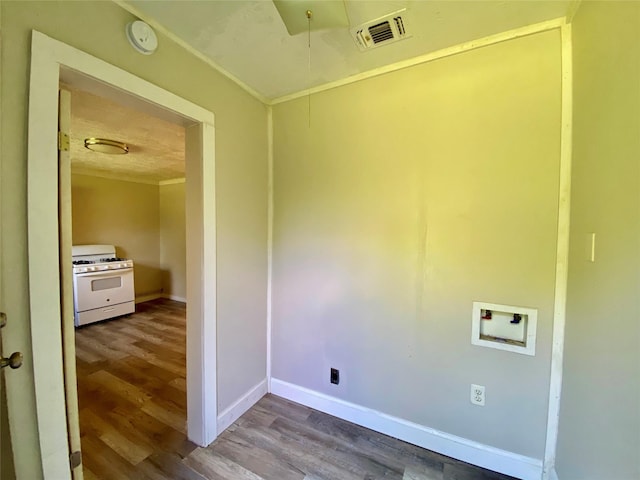 503 SW 15th Ave, Mineral Wells, TX 76067 - washroom featuring wood finished floors, baseboards, hookup for a washing machine, attic access, and crown molding