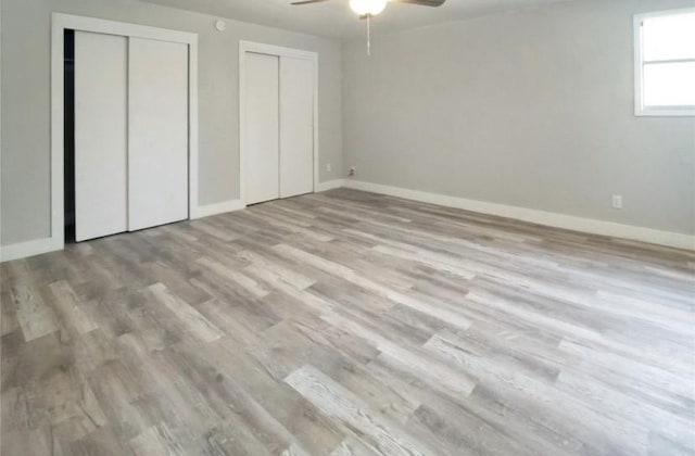 503 SW 15th Ave, Mineral Wells, TX 76067 - unfurnished bedroom featuring multiple closets, wood finished floors, and baseboards