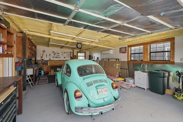 5900 Florance Rd, Northlake, TX 76247 - garage featuring an AC wall unit and a workshop area