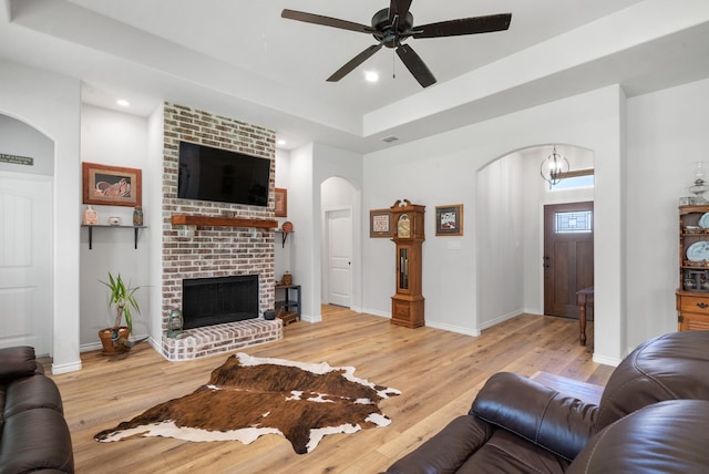 355 Sunset Cv, Bluff Dale, TX 76433 - living area with arched walkways, ceiling fan, light wood-style flooring, recessed lighting, and a brick fireplace