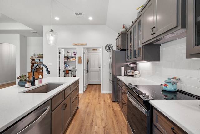 355 Sunset Cv, Bluff Dale, TX 76433 - kitchen with stainless steel appliances, a sink, light countertops, pendant lighting, and arched walkways