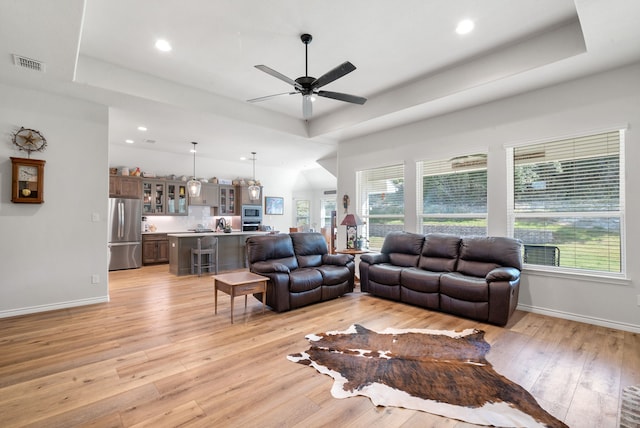 355 Sunset Cv, Bluff Dale, TX 76433 - living room featuring a tray ceiling, light wood-style flooring, ceiling fan, baseboards, and recessed lighting