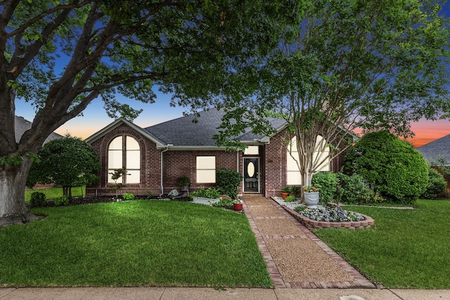 4055 Seabury Dr, Dallas, TX 75287 - view of front facade featuring a shingled roof, brick siding, and a lawn
