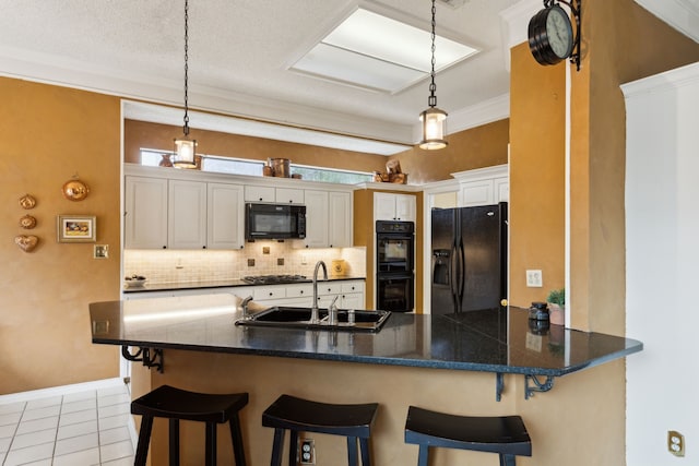 4055 Seabury Dr, Dallas, TX 75287 - kitchen with black appliances, a sink, backsplash, a peninsula, and dark countertops