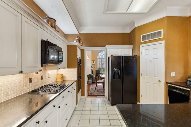 4055 Seabury Dr, Dallas, TX 75287 - kitchen with black appliances, crown molding, decorative backsplash, light tile patterned floors, and white cabinetry