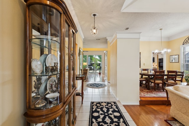 4055 Seabury Dr, Dallas, TX 75287 - foyer entrance featuring a chandelier, crown molding, baseboards, a textured ceiling, and light tile patterned flooring