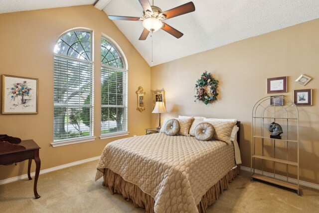 4055 Seabury Dr, Dallas, TX 75287 - carpeted bedroom featuring multiple windows, lofted ceiling, baseboards, and a ceiling fan