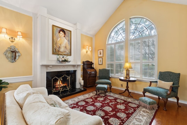 4055 Seabury Dr, Dallas, TX 75287 - living room featuring wood finished floors, lofted ceiling, a premium fireplace, and baseboards