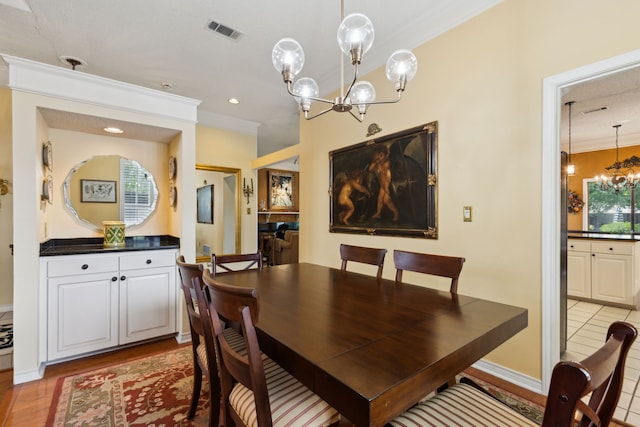 4055 Seabury Dr, Dallas, TX 75287 - dining space featuring a chandelier, ornamental molding, and light wood-type flooring