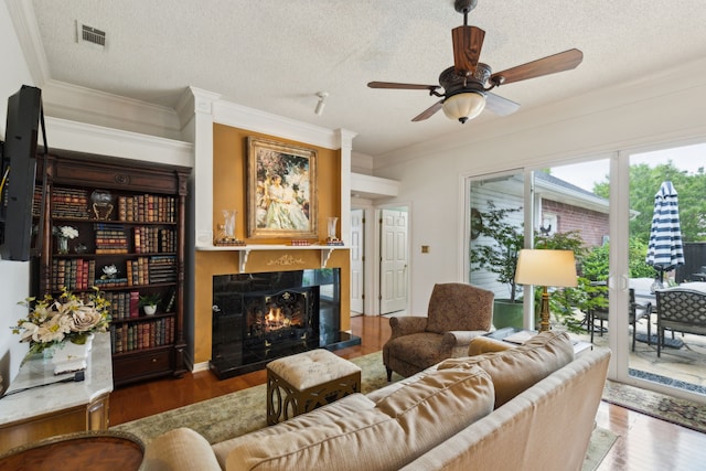 4055 Seabury Dr, Dallas, TX 75287 - living area with wood finished floors, a textured ceiling, a high end fireplace, a ceiling fan, and crown molding