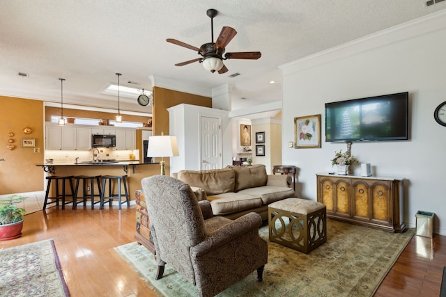 4055 Seabury Dr, Dallas, TX 75287 - living room featuring crown molding, ceiling fan, and light wood-style floors