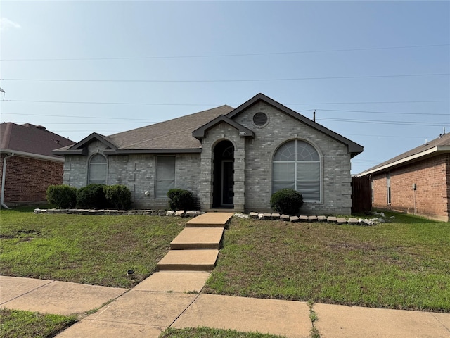 2825 Saint Croix Ave, Lancaster, TX 75134 - view of front of home with brick siding, a front yard, and a shingled roof