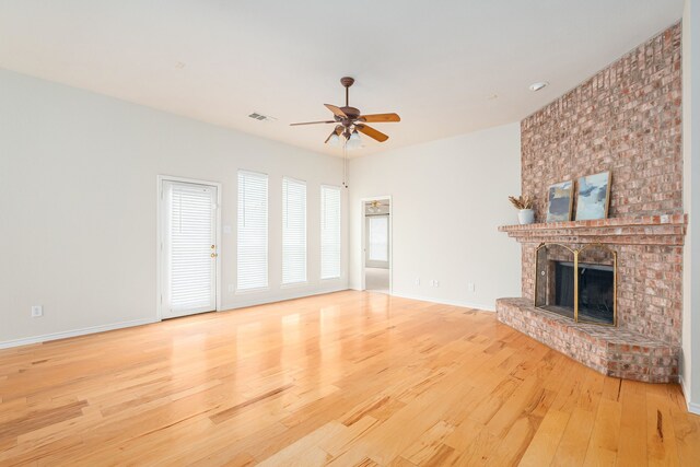5508 Periwinkle Ln, Mckinney, TX 75070 - unfurnished living room with light wood-style flooring, a ceiling fan, a brick fireplace, and baseboards