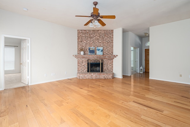 5508 Periwinkle Ln, Mckinney, TX 75070 - unfurnished living room featuring light wood-style floors, ceiling fan, a fireplace, and baseboards