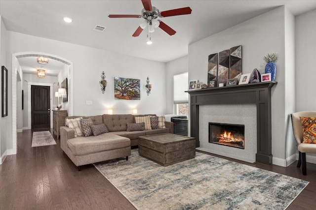 309 Bluffside Trl, Benbrook, TX 76126 - living area featuring dark wood-style floors, a ceiling fan, a glass covered fireplace, baseboards, and recessed lighting