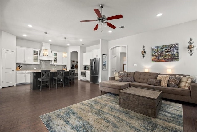 309 Bluffside Trl, Benbrook, TX 76126 - living area with arched walkways, ceiling fan, dark wood finished floors, and recessed lighting