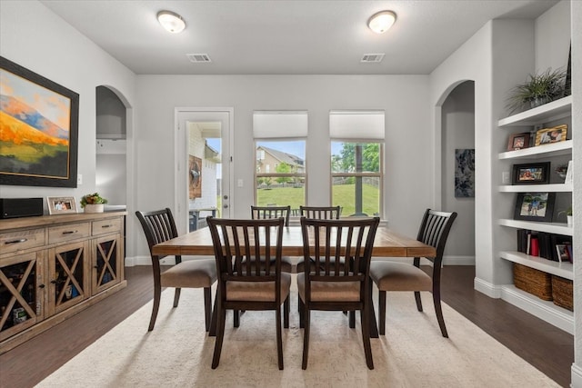 309 Bluffside Trl, Benbrook, TX 76126 - dining area featuring built in shelves, baseboards, and wood finished floors