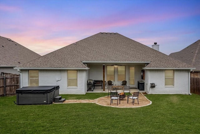 309 Bluffside Trl, Benbrook, TX 76126 - back of property at dusk featuring a hot tub, a shingled roof, a patio area, and a chimney