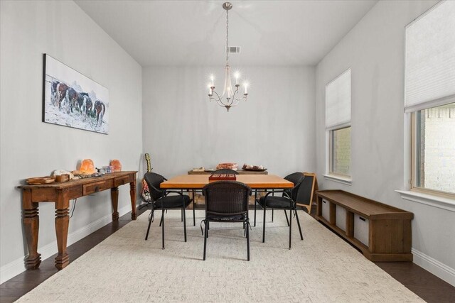 309 Bluffside Trl, Benbrook, TX 76126 - dining area with a chandelier, wood finished floors, and baseboards