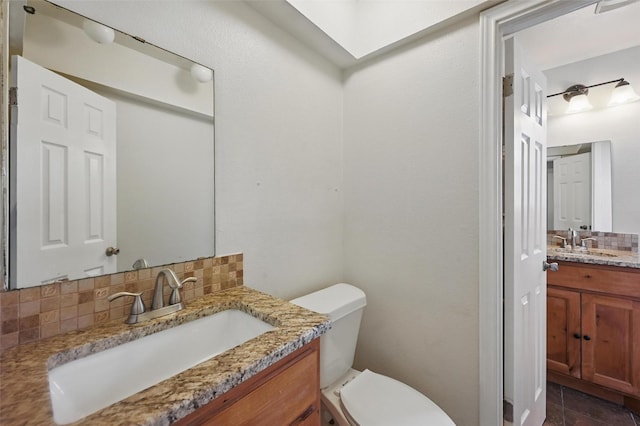 5833 Westhaven Dr, Fort Worth, TX 76132 - bathroom with tasteful backsplash, toilet, and vanity