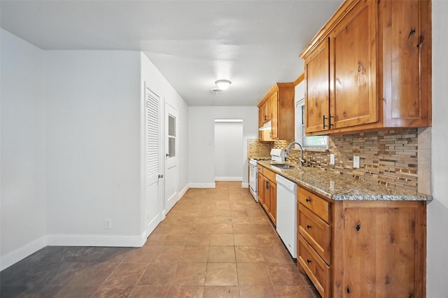 5833 Westhaven Dr, Fort Worth, TX 76132 - kitchen featuring white appliances, tasteful backsplash, brown cabinets, a sink, and baseboards